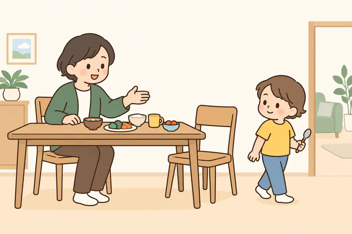 食事の途中でいすから降りて立っている子どもと、食卓から声をかける大人