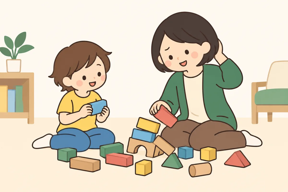 崩れた積み木を前に、大人が照れ笑いをして、もう一度積み直している。
