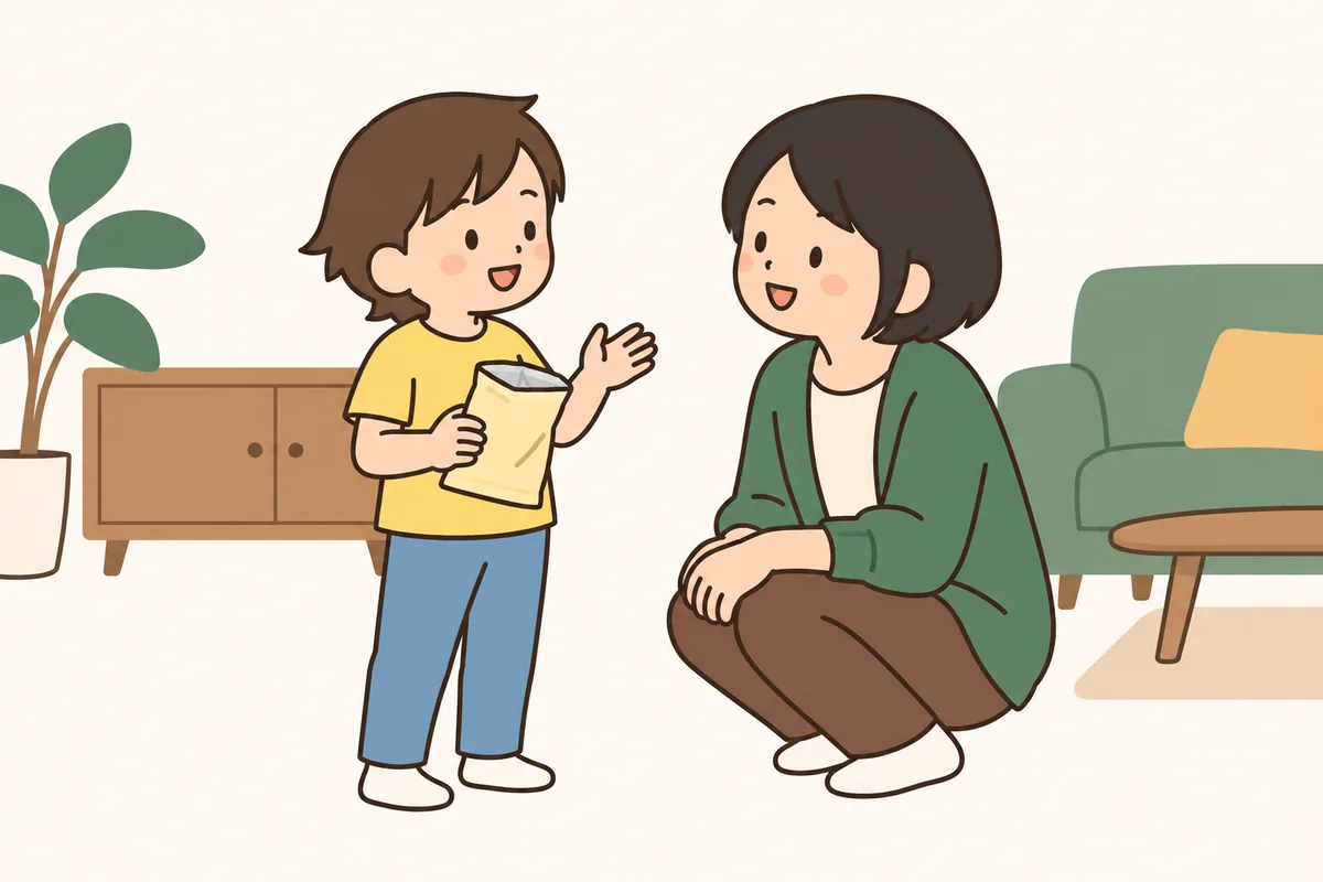 大人がしゃがんで、子どもと向き合い、穏やかに話しかけている。