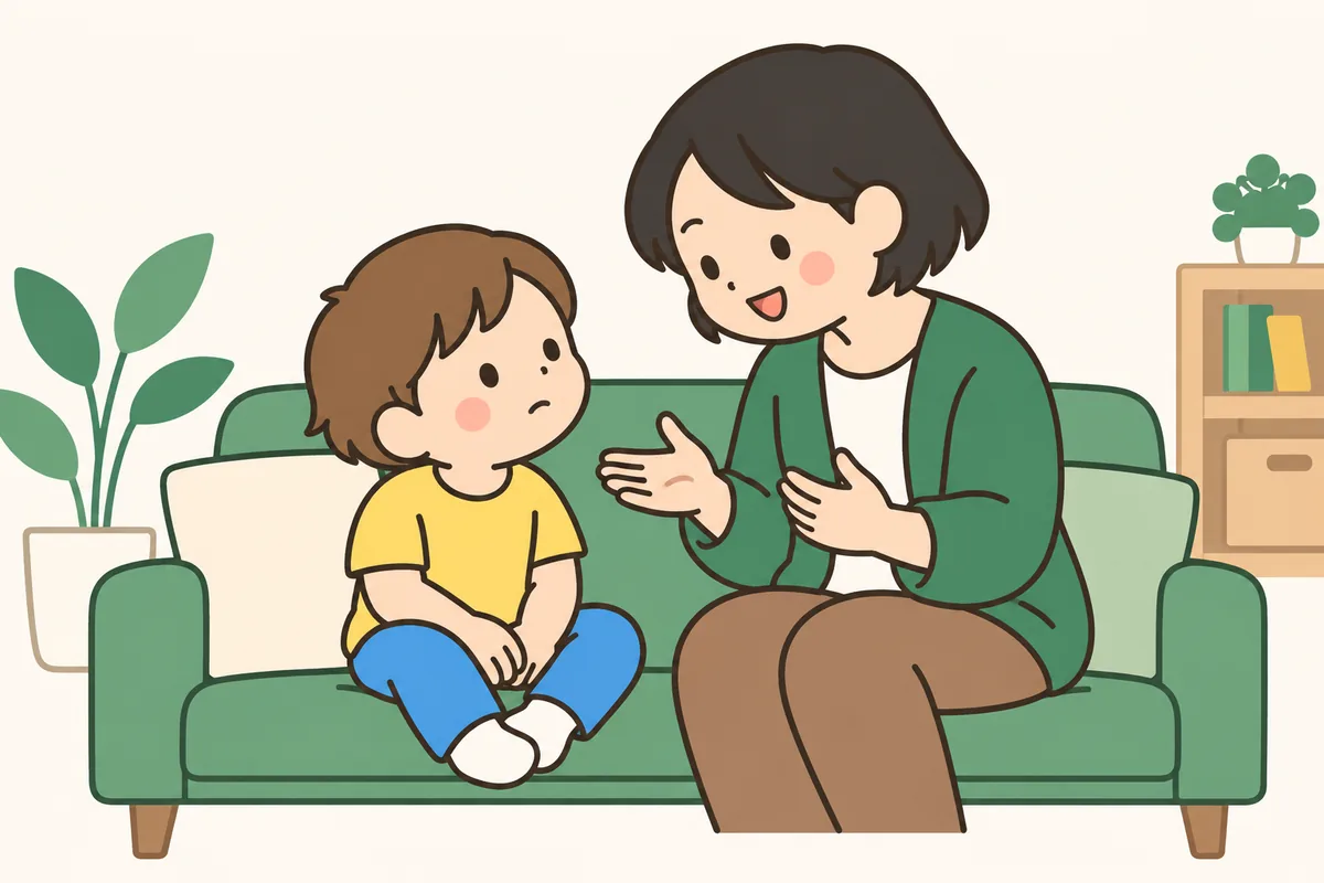ソファで落ち着いている子どもに、大人が向き合って穏やかに話している