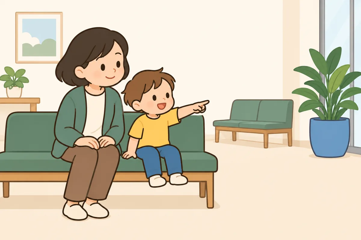 待合のベンチに並んで座り、子どもが離れた所の青い物を指さし、大人がのぞきこんでいる
