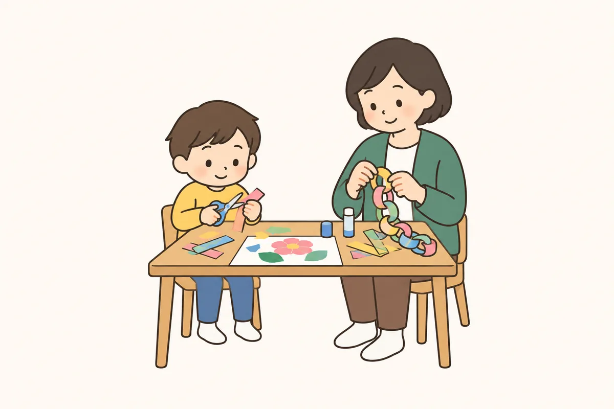 子どもが子ども用のはさみで細長い紙を切り、横で大人が紙の輪をのりでつないでいる