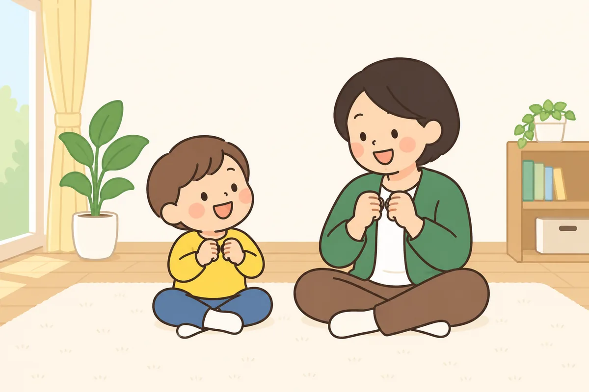 向かい合って座った大人と子どもが、歌いながら同じ手の動きをしている